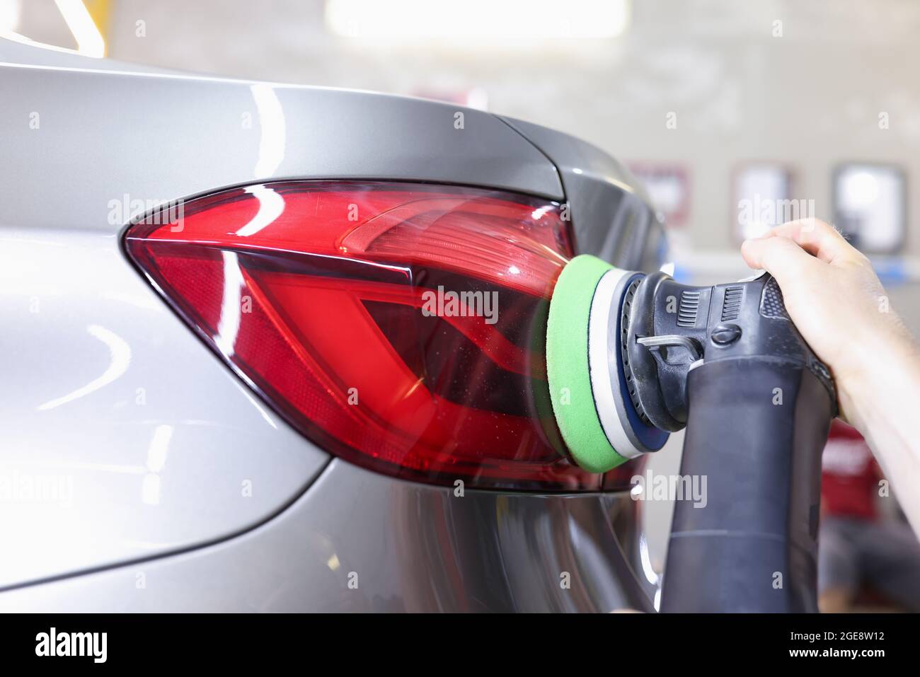 Detailing and polishing of car tail light on car closeup Stock Photo