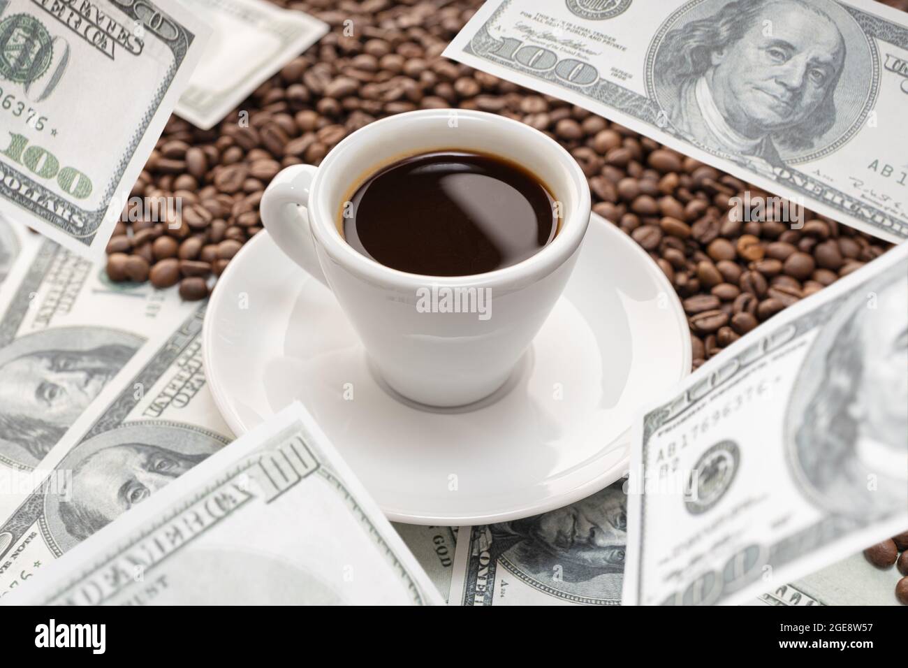 Cup of coffee on Coffee beans and dollar banknotes flying around it. Rising  coffee prices concept Stock Photo - Alamy