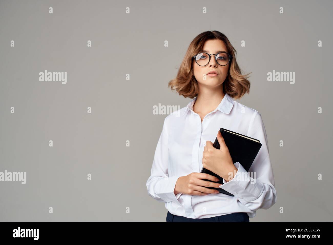 Business woman in white shirt documents office manager posing Stock ...