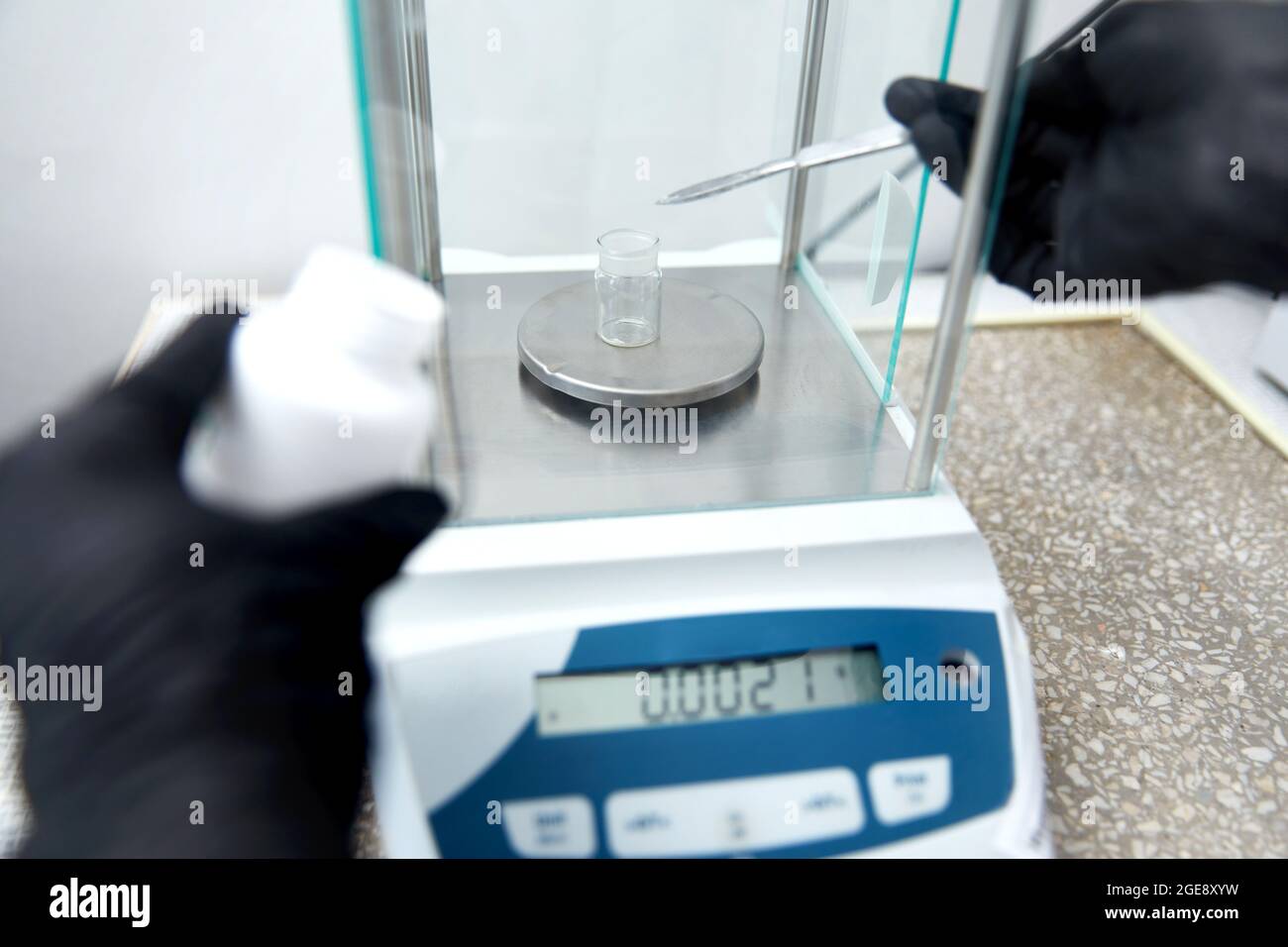 Scientist weighing chemicals by digital scales in grams in chemical laboratory Stock Photo