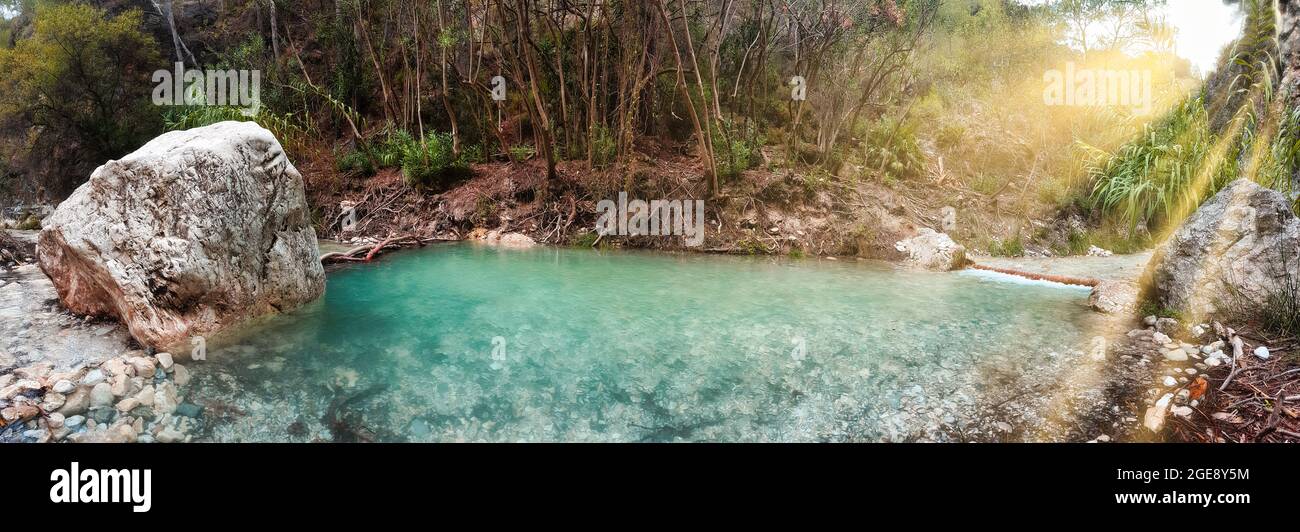 Small waterfall in the jungle with turquoise water, panorama Stock Photo