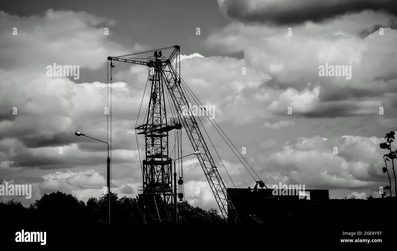 construction crane on the background of a cloudy sky, monochrome Stock ...