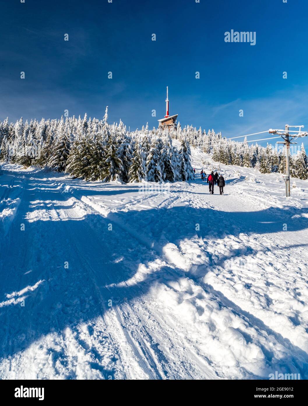 Lysa hora hill with communication tower, frozen trees, snow covered road  and few hikers in winter Moravskoslezske Beskydy mountains in Czech  republic Stock Photo - Alamy