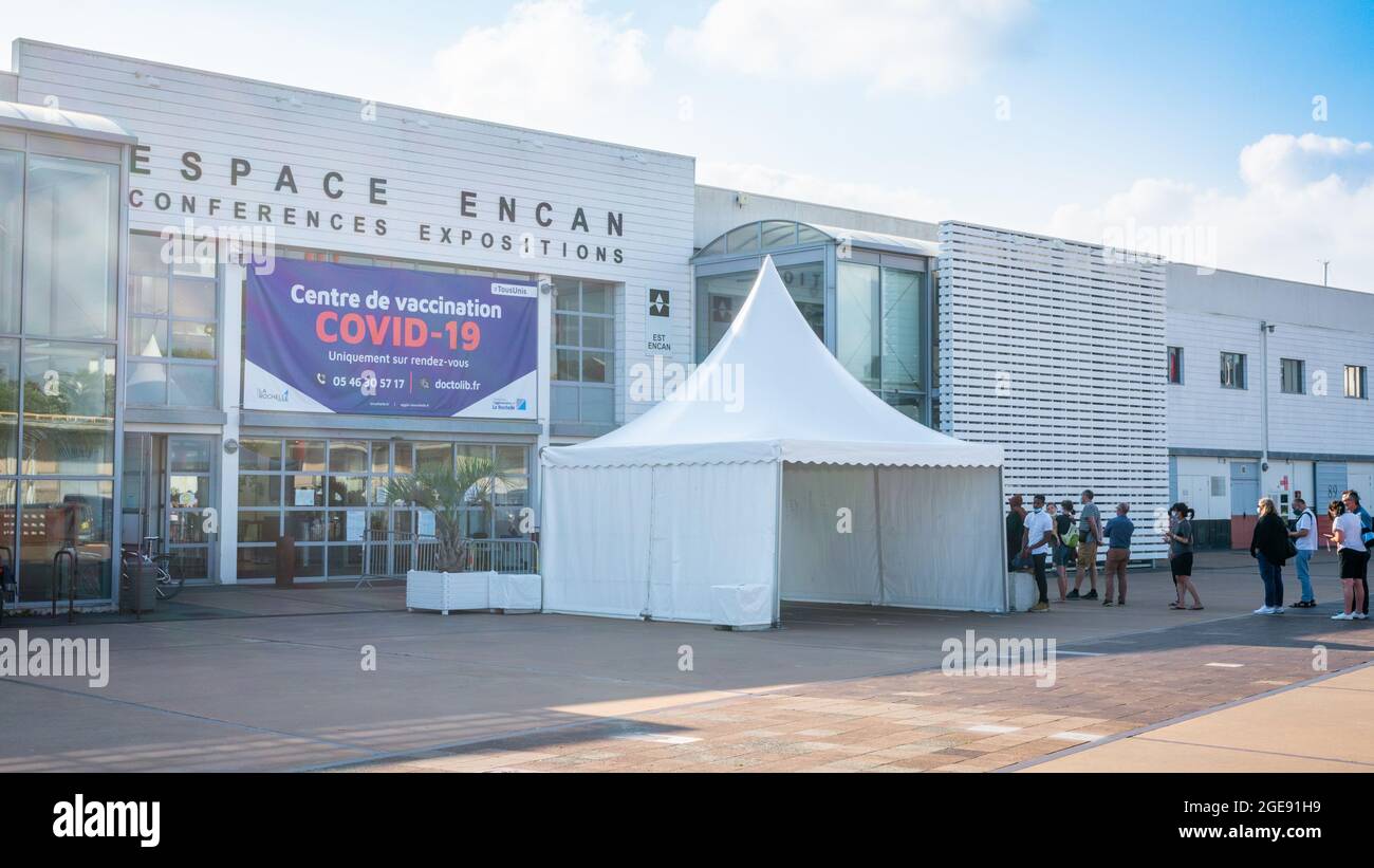 27 July 2021 , La Rochelle France : View of Covid vaccination center of Espace Encan and people queuing-up in front of it during summer 2021 in La Roc Stock Photo