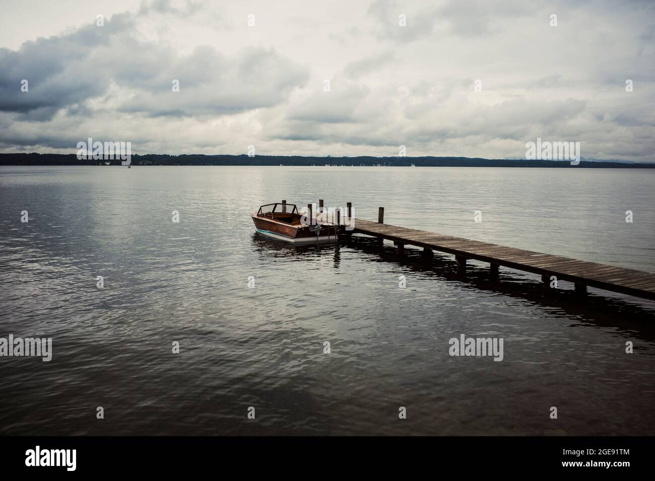motorboat and wooden pier on the lake Stock Photo