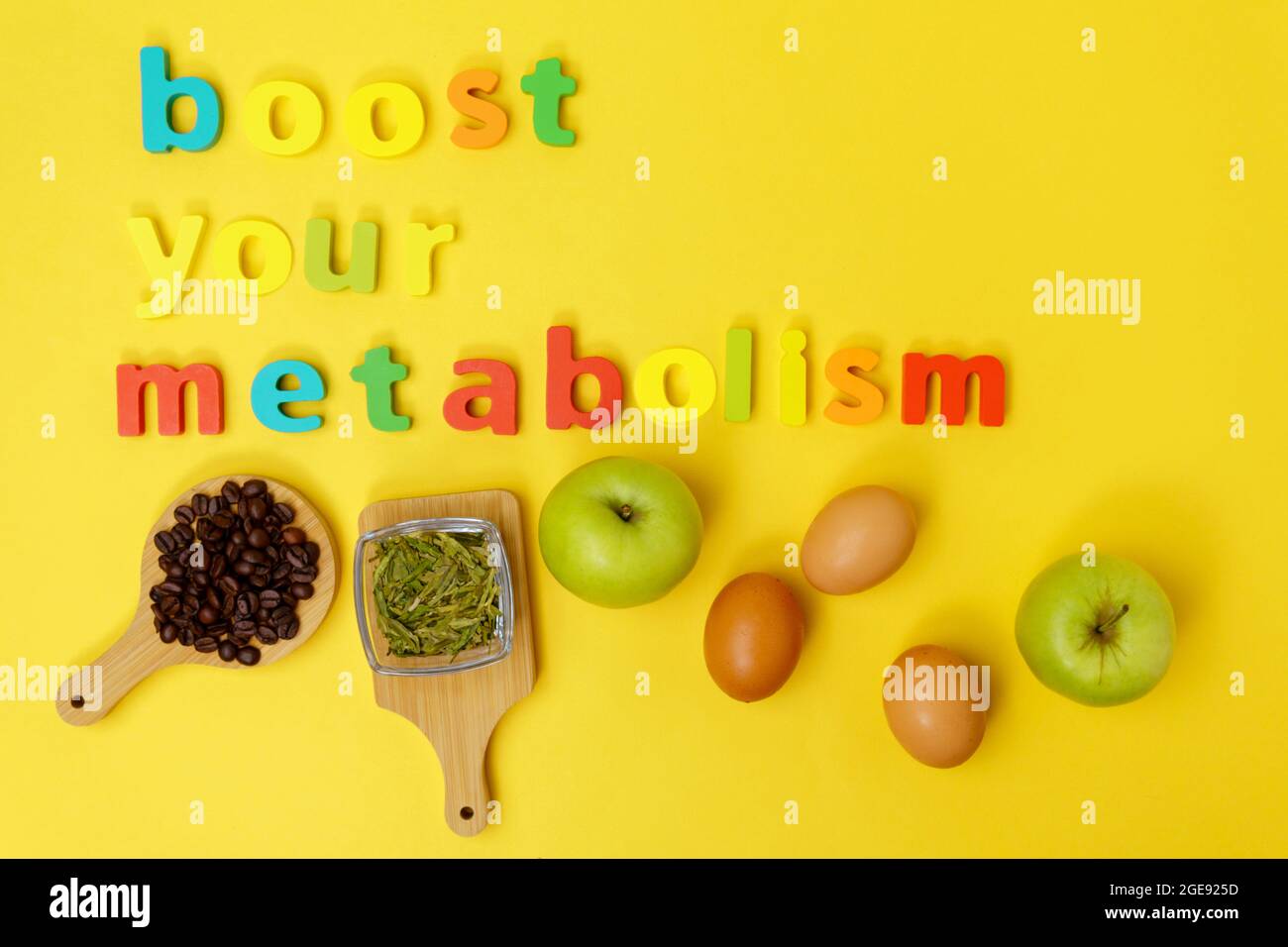 Boost your metabolism eggs, coffee, green tea, apple on a yellow background  top view Stock Photo - Alamy