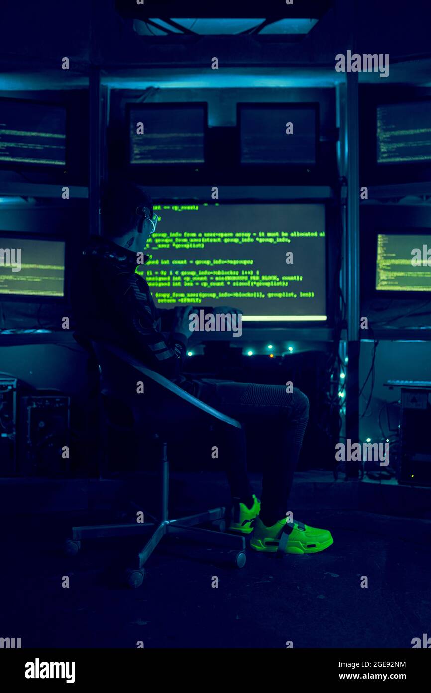 Cyber hacker breaks into databases to obtain information using a computer. Cybercrime and data security concept. Stock Photo