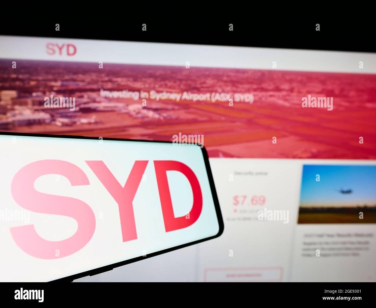 Smartphone with logo of Australian company Sydney Airport Holdings Pty Ltd on screen in front of website. Focus on center-right of phone display. Stock Photo