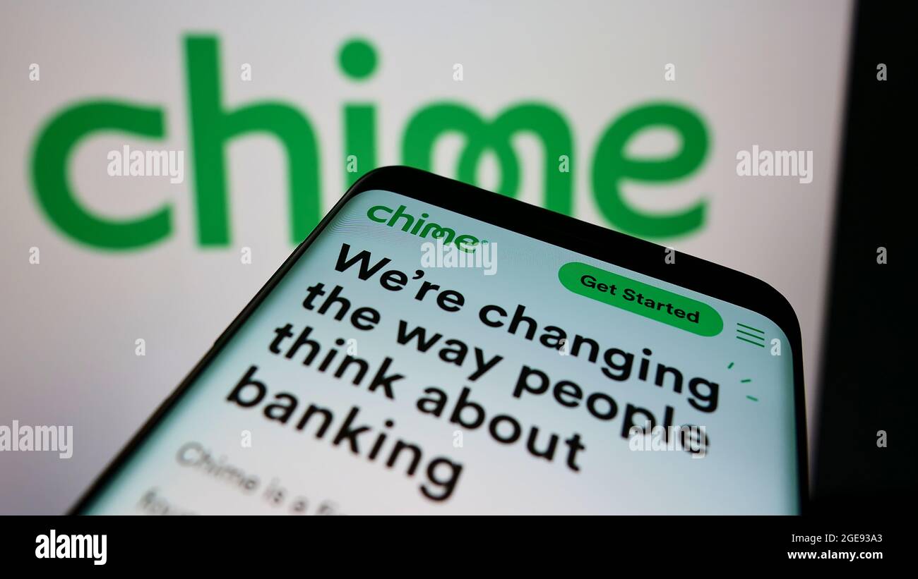 Mobile phone with webpage of American fintech company Chime Financial Inc. on screen in front of business logo. Focus on top-left of phone display. Stock Photo