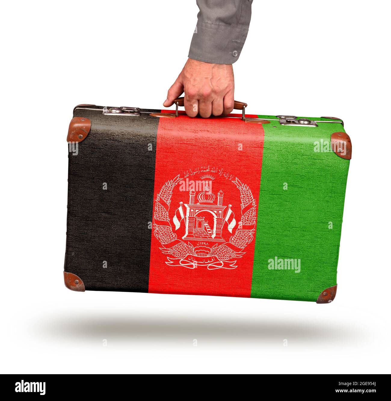 Hand holding and carrying vintage Afghanistan flag suitcase isolated on white Stock Photo