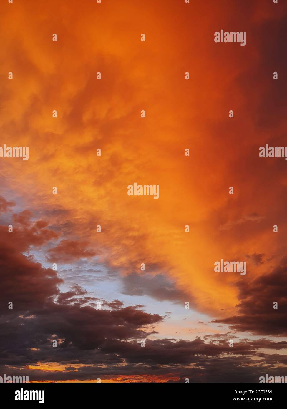 Colorful autumn sunset sky. Vertical background, abstract clouds shapes and colors. October seasonal celestial beauty. Panoramic dusk cloudscape scene Stock Photo