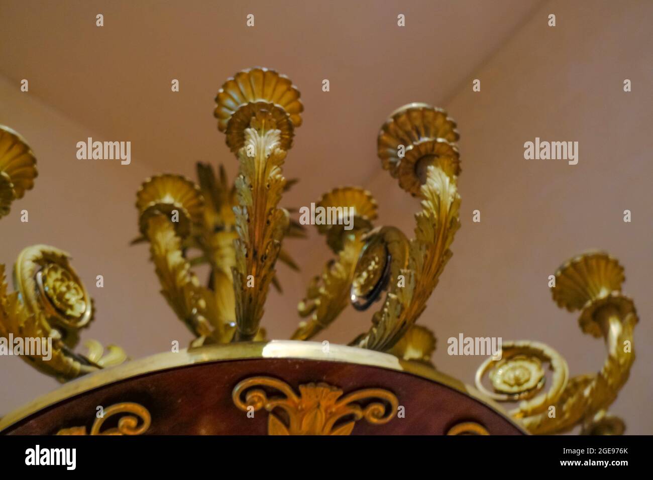 Vintage golden candleholder across the ceiling close-up. Interior decor. Lightning equipment Stock Photo