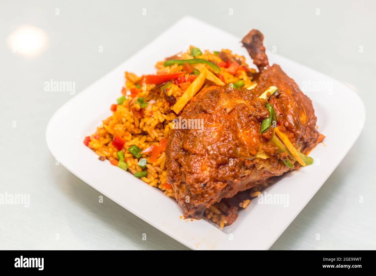 Jollof rice and chicken with salad Stock Photo Alamy