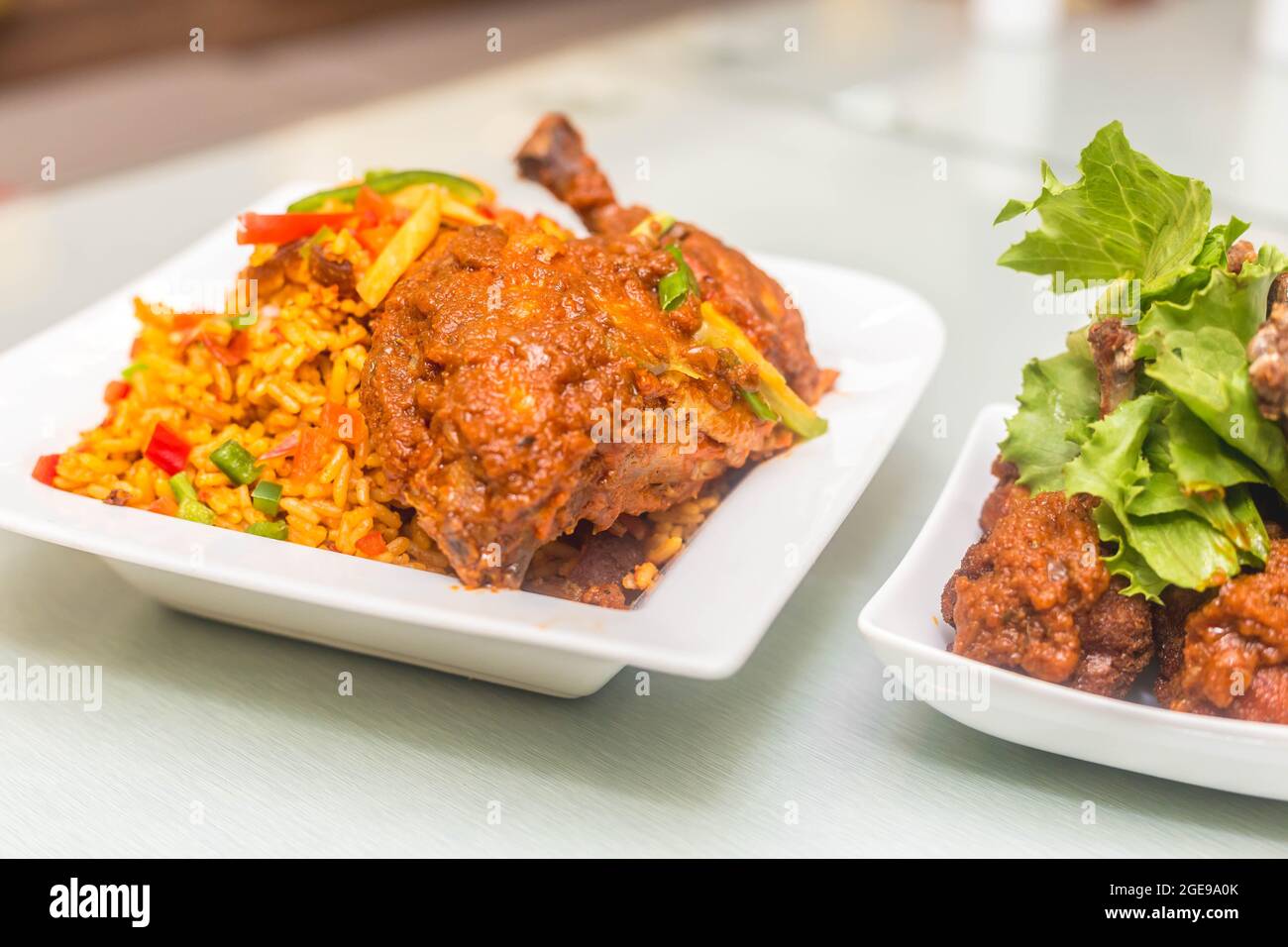 Jollof rice and chicken with salad Stock Photo Alamy