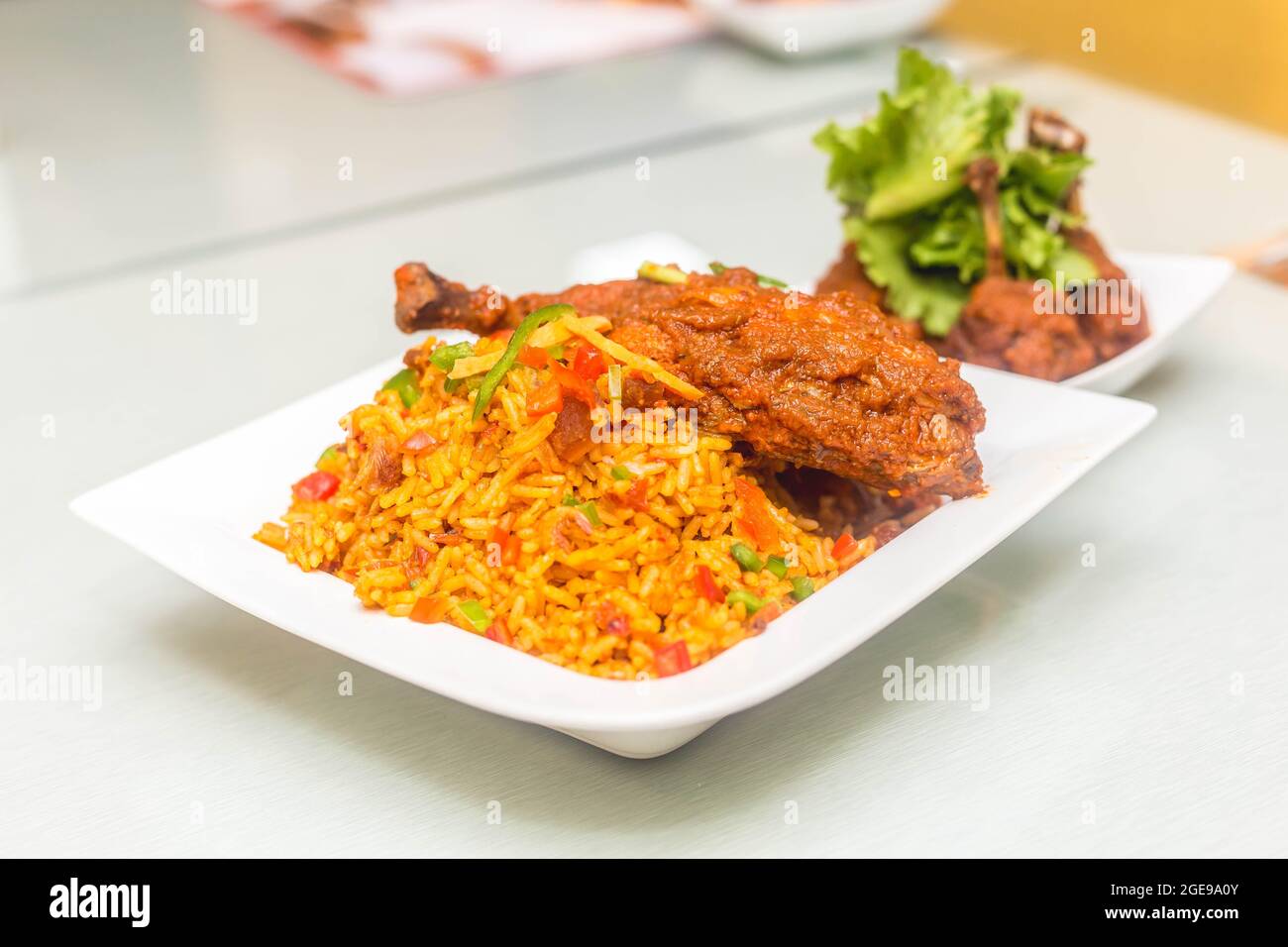 Jollof rice and chicken with salad Stock Photo - Alamy