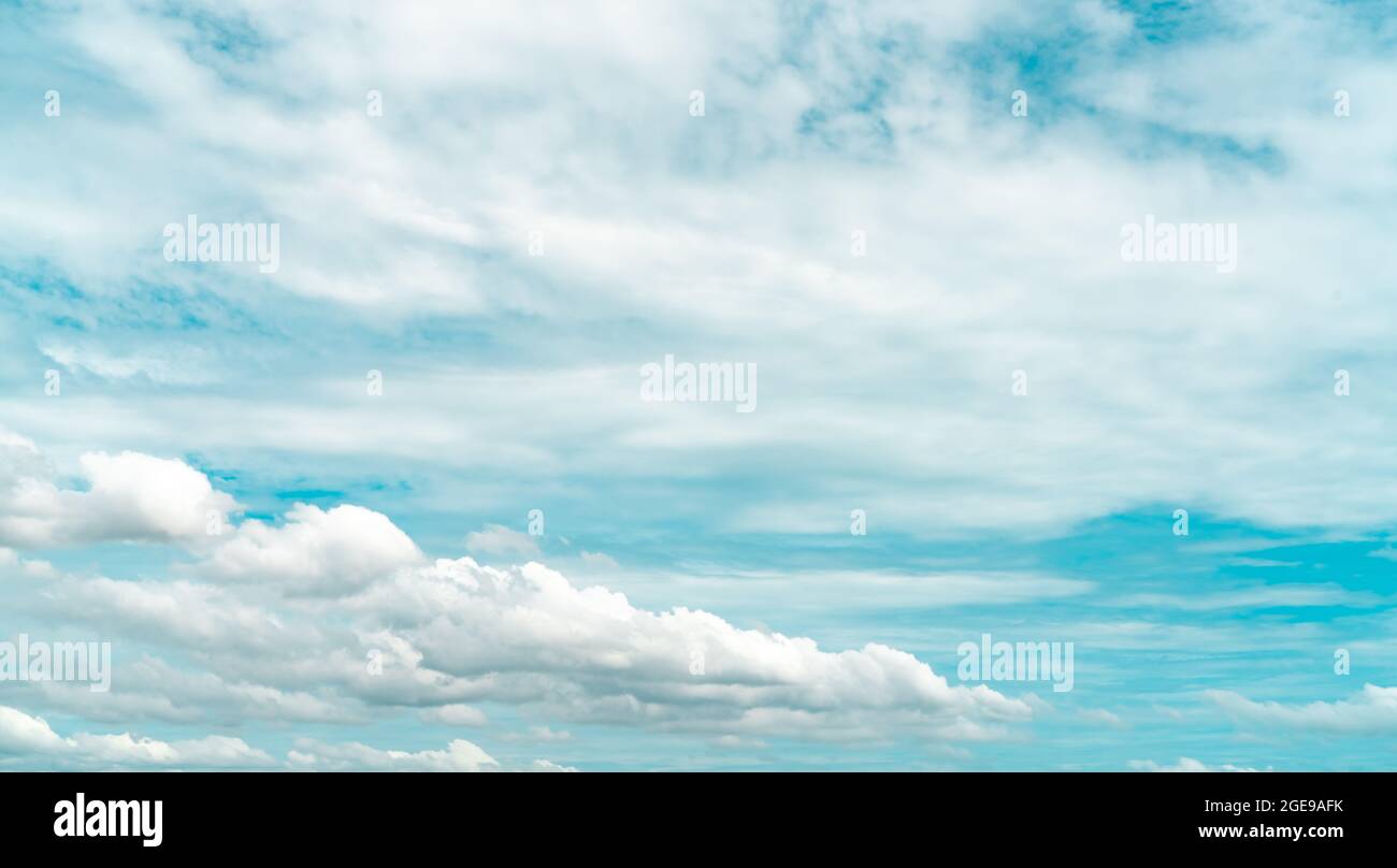 White fluffy clouds on blue sky. Soft touch feeling like cotton. White puffy cloudscape. Beauty in nature. White cumulus clouds texture background. Stock Photo