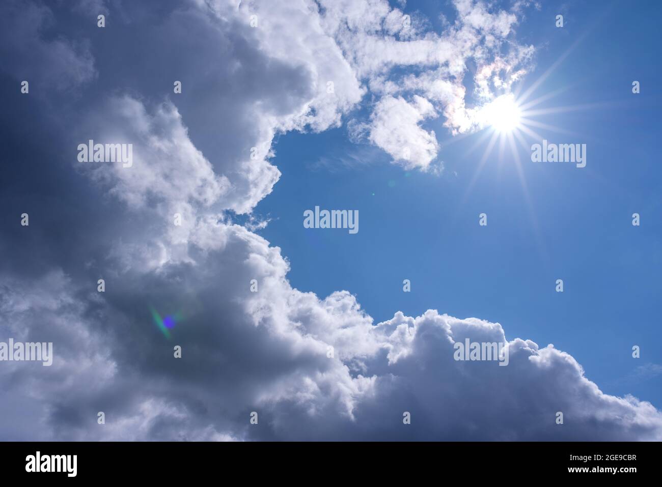 Light shining throug dark clouds. Stock Photo