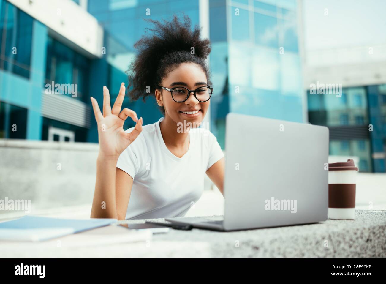 African American Female Student Gesturing Okay Using Laptop Sitting ...