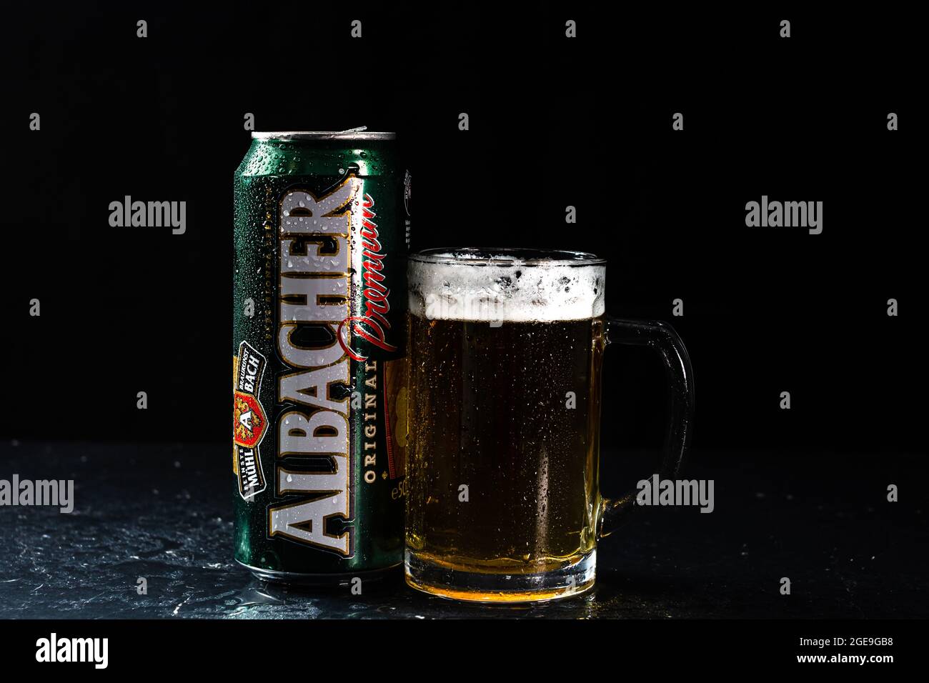 Can of Albacher beer and beer glass on dark background. Illustrative ...