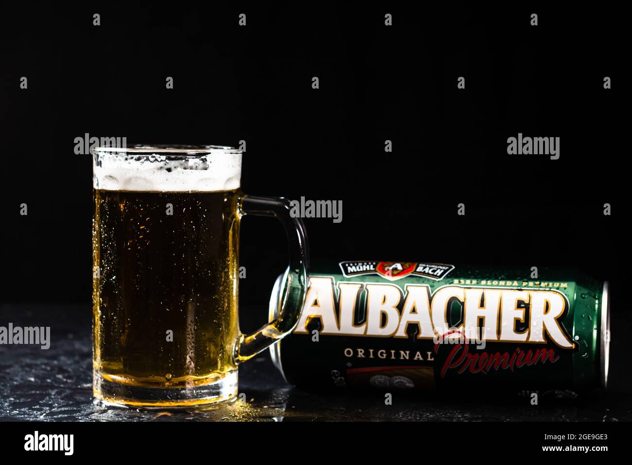 Can of Albacher beer and beer glass on dark background. Illustrative ...
