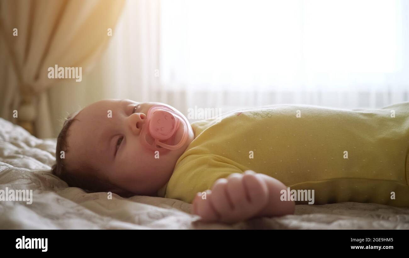 Closeup of a sleeping baby with a pacifier in mouth Stock Photo Alamy