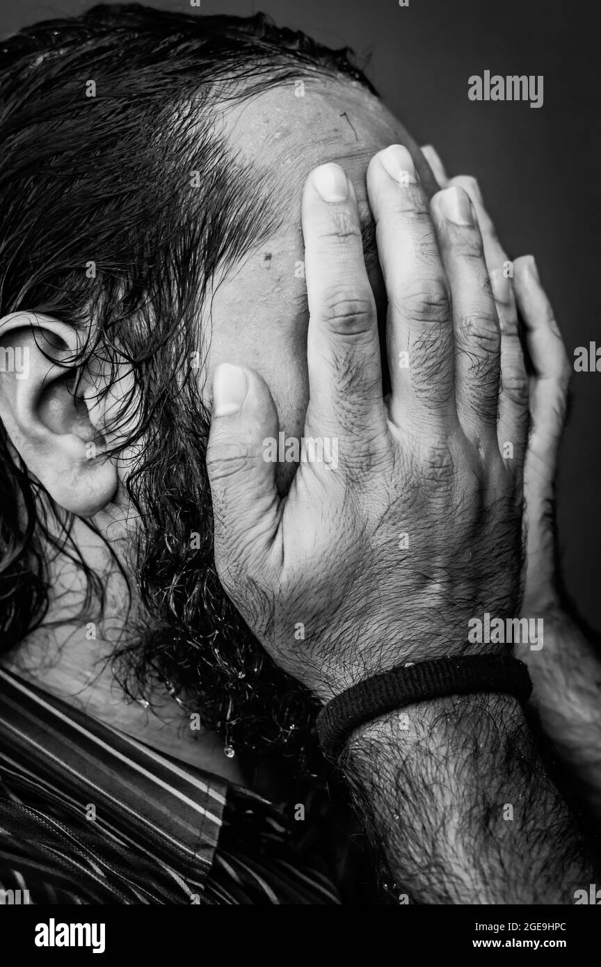 black and white portrait of a young man with a beard and long hair ...