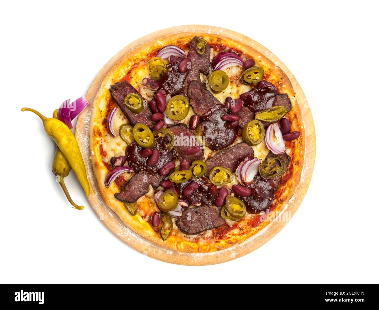 Pizza with beef fillet slices, green chili peppers, red onions and kidney beans on wooden platter isolated on white background, high angle view Stock Photo