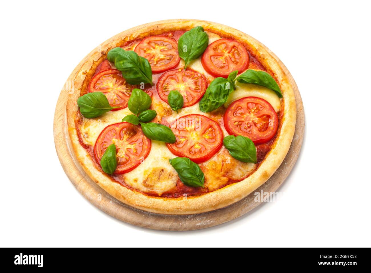 Pizza Margherita with tomato slices, mozzarella cheese and fresh basil leaves on wooden platter isolated on white background Stock Photo