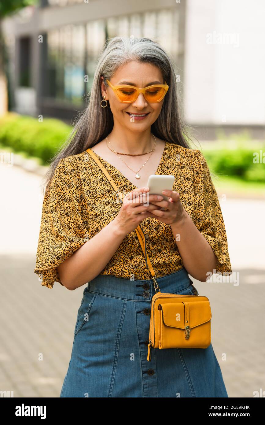 Mature woman smartphone typing hi-res stock photography and images - Alamy