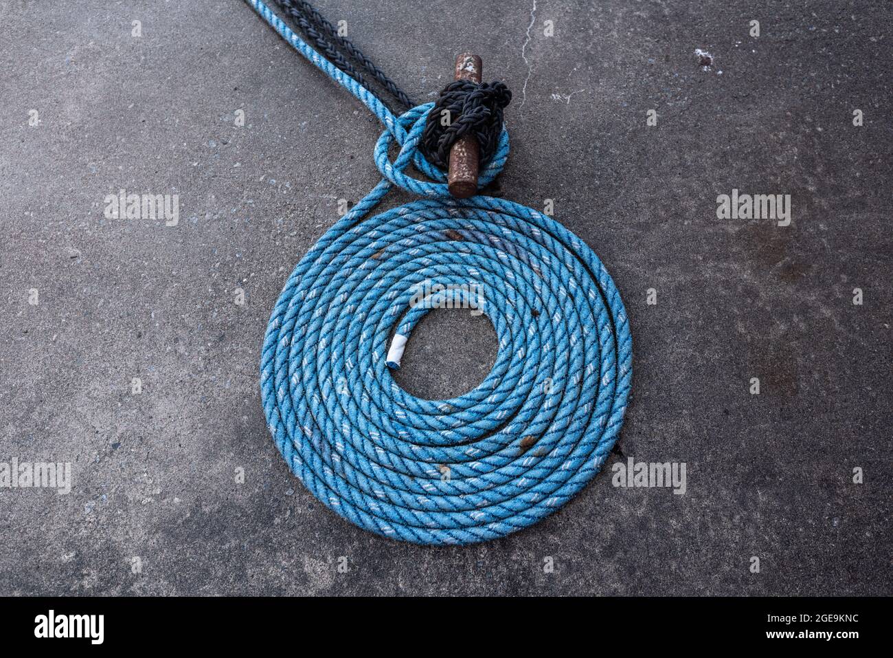 Blue mooring rope laid down in a spiral Stock Photo