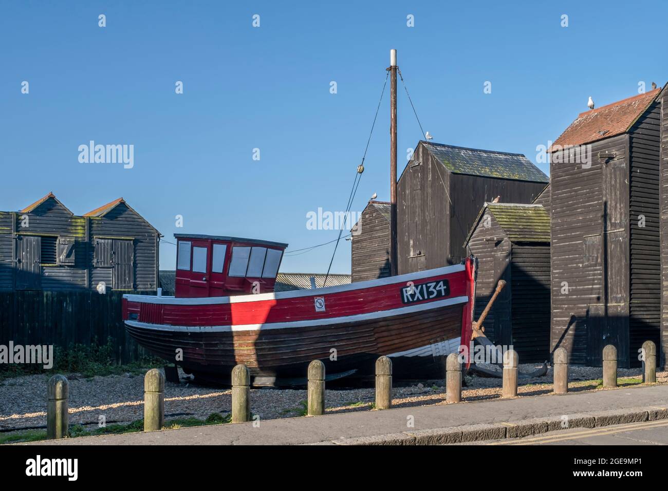 An old fishing boat amid the Net Shops on Hastings heritage trail. Stock Photo