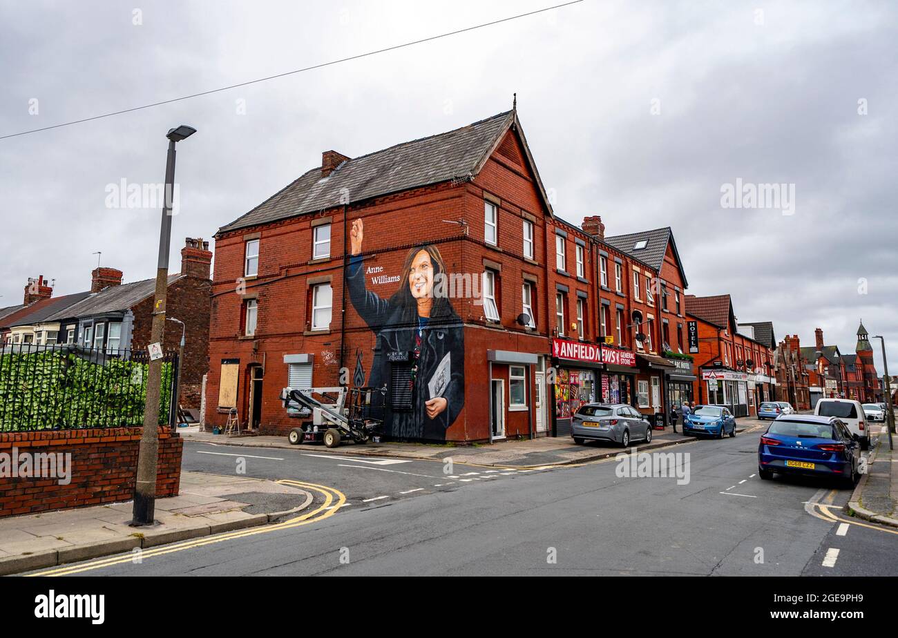 Artist Paul Curtis paints a mural of Anne Williams, the mother of