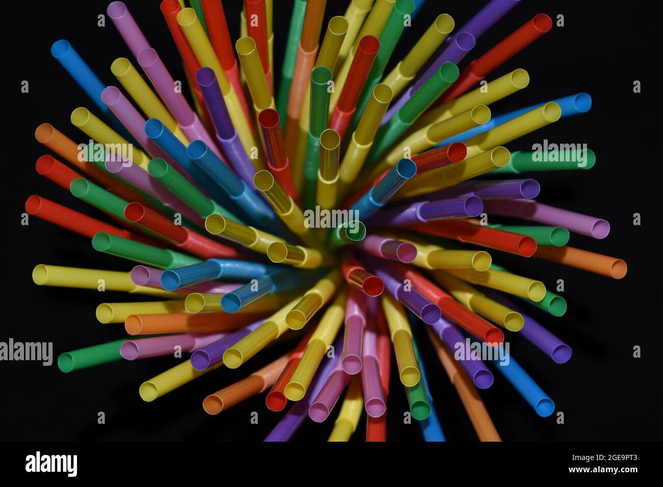 Multicolored straws isolated on black background. Stock Photo