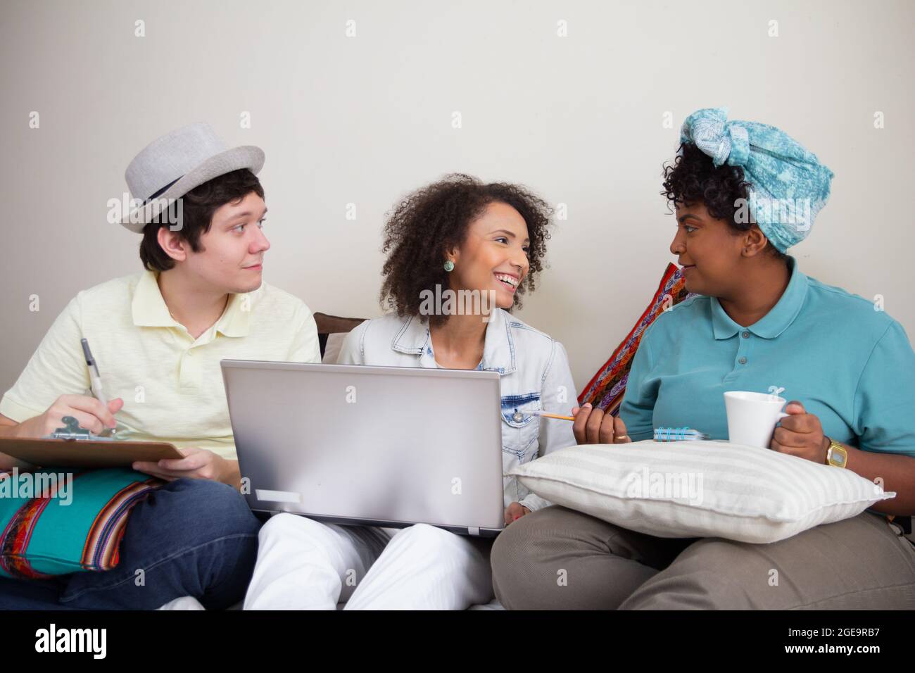 Multiethnic university rommates helping each other with studies work. Group study for effective communication, teamwork and togetherness. Stock Photo