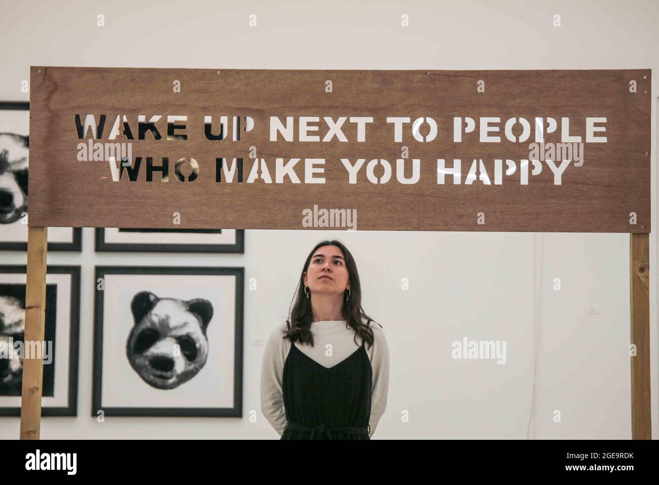 London UK 18 August 2021 RIGHT HERE RIGHT NOW. Wake up next to the people who makes you happy, 2021 . The 4,000 sq. ft exhibition will open in two gallery spaces at Saatchi Gallery on Thursday, 19 August 2021 until 9 September 2021.The exhibition features artworks by established artists such as Jake & Dinos Chapman, Charming Baker, David Shrigley and Chris Levine together with works by London based painter Matt Small and mural & installation artist Morag Myerscough. The show will also include previously unseen original work by Gary Stranger, Jessica Albarn, Eelus, Sara Pope and an exciting new Stock Photo