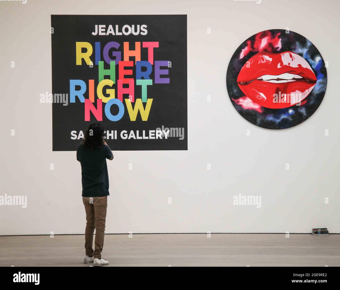 London UK 18 August 2021 RIGHT HERE RIGHT NOW. The 4,000 sq. ft exhibition will open in two gallery spaces at Saatchi Gallery on Thursday, 19 August 2021 until 9 September 2021.The exhibition features artworks by established artists such as Jake & Dinos Chapman, Charming Baker, David Shrigley and Chris Levine together with works by London based painter Matt Small and mural & installation artist Morag Myerscough. The show will also include previously unseen original work by Gary Stranger, Jessica Albarn, Eelus, Sara Pope and an exciting new collaboration between Andrew Millar & Word To Mother.P Stock Photo
