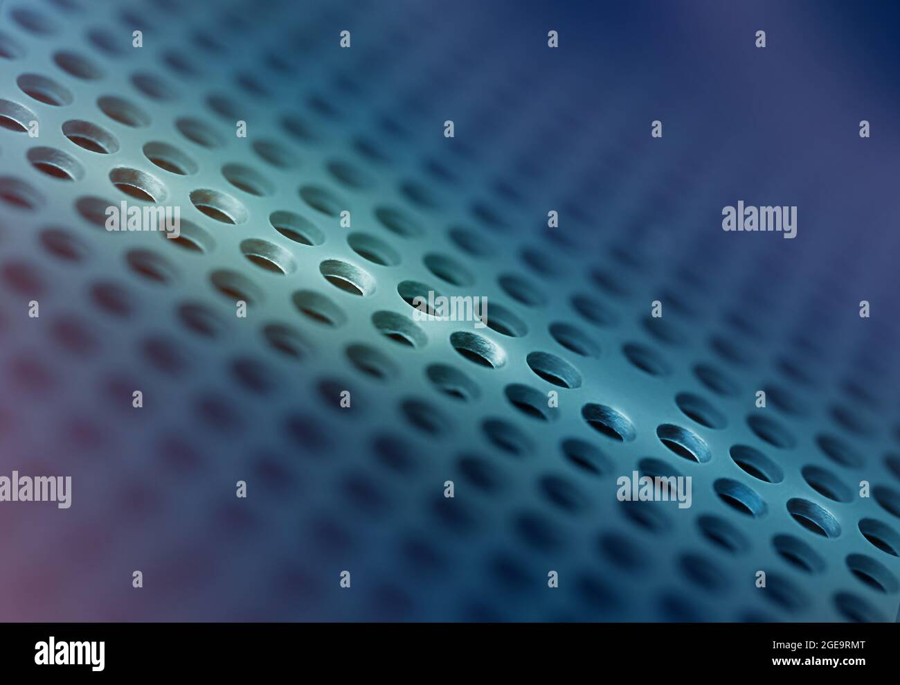 Macro photography on the topic of technology. abstract background of blue color with small holes. The light beam illuminates the space. Stock Photo