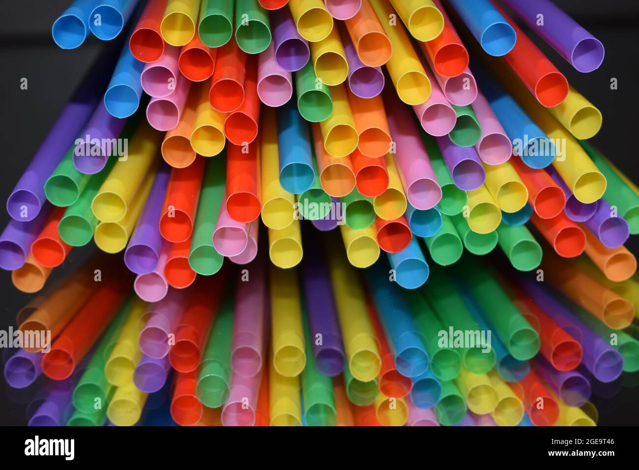 Multicolored straws isolated on black background. Stock Photo