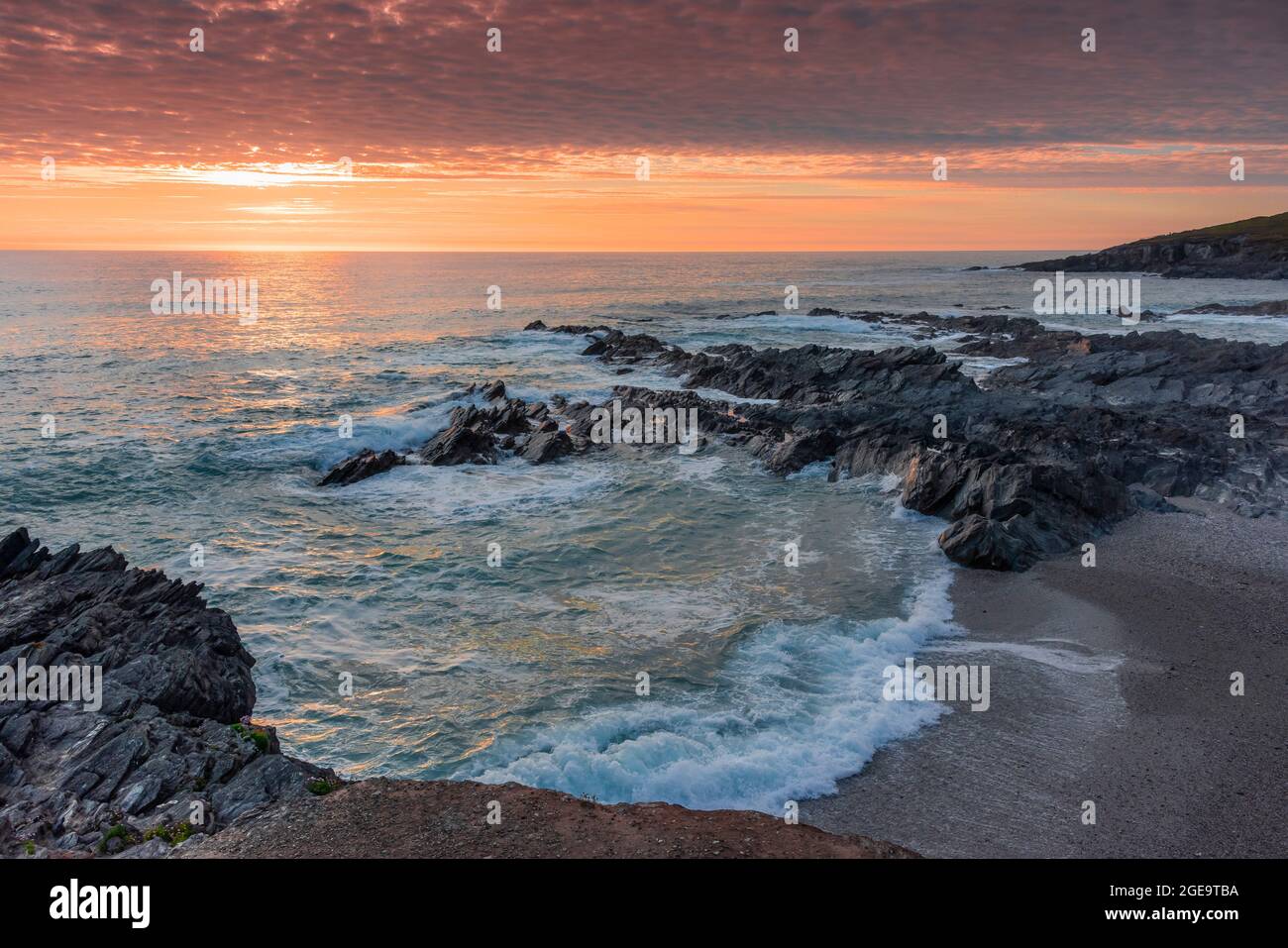 A spectacular sunset over Fistral Bay on the coast of Newquay in Cornwall. Stock Photo