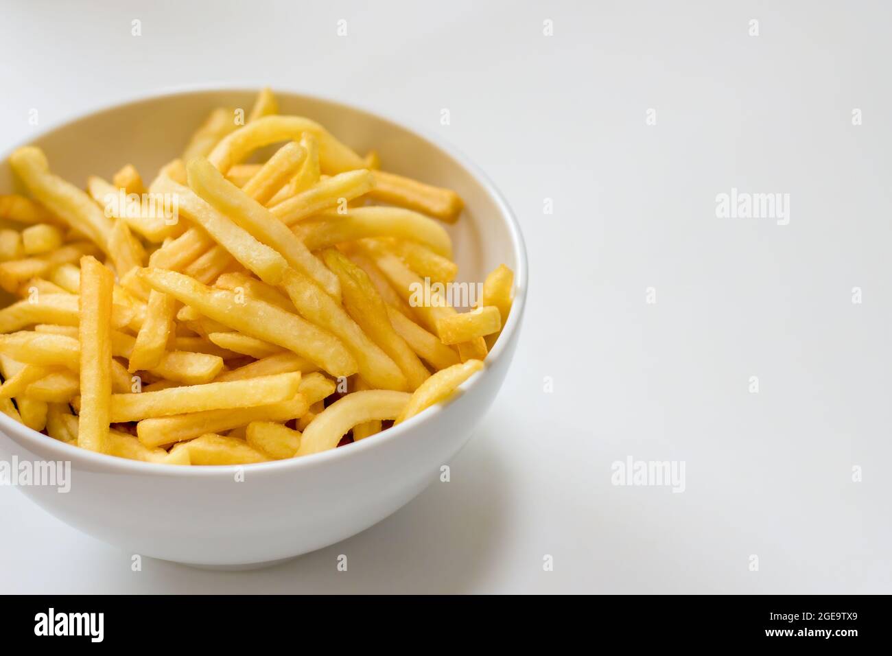 Full bowl of french fries on a white background Stock Photo