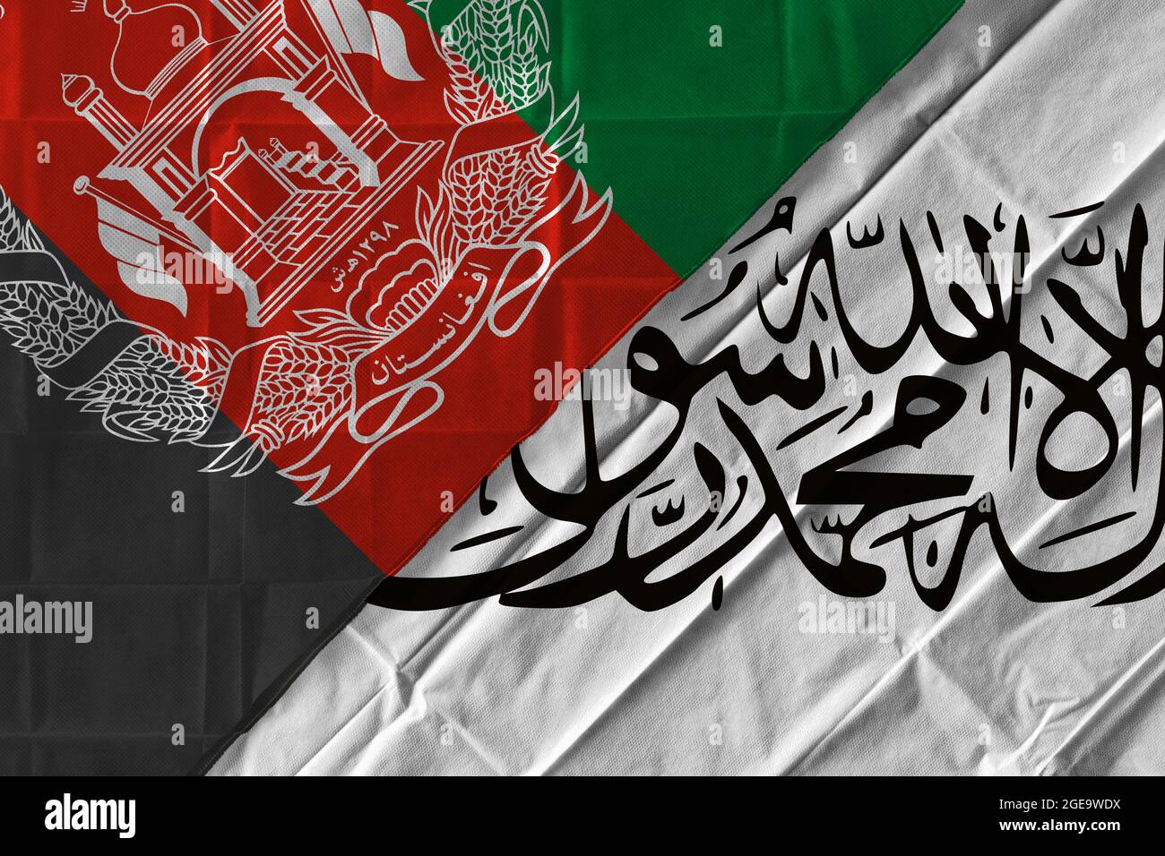 Concept of the situation in Afghanistan with flags of the Government and the Taliban over each other Stock Photo
