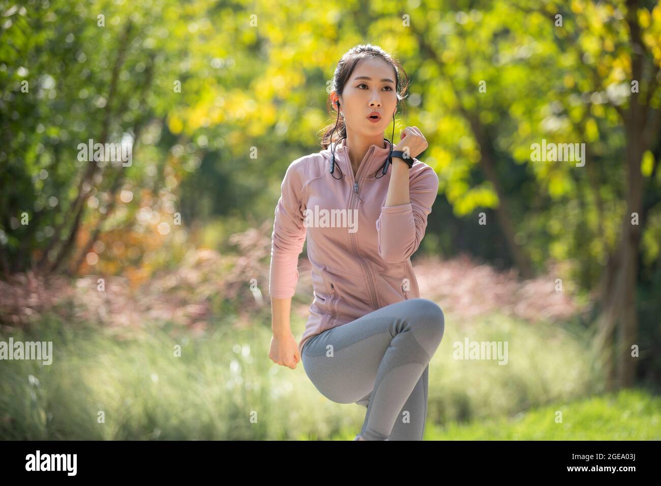 Young Chinese woman exercising in park Stock Photo - Alamy