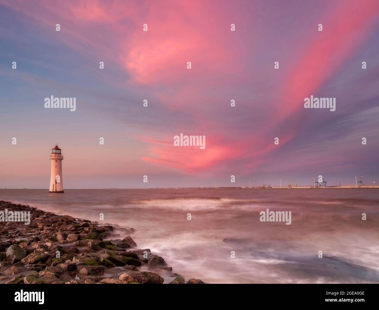 Colourful pink sunset at New Brighton Lighthouse. Stock Photo