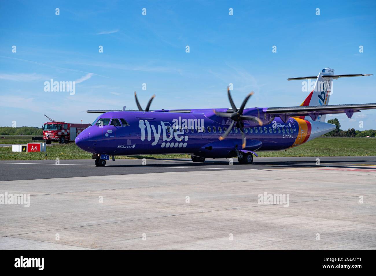 A Flybe aircraft taxis towards the runway for take off. Stock Photo
