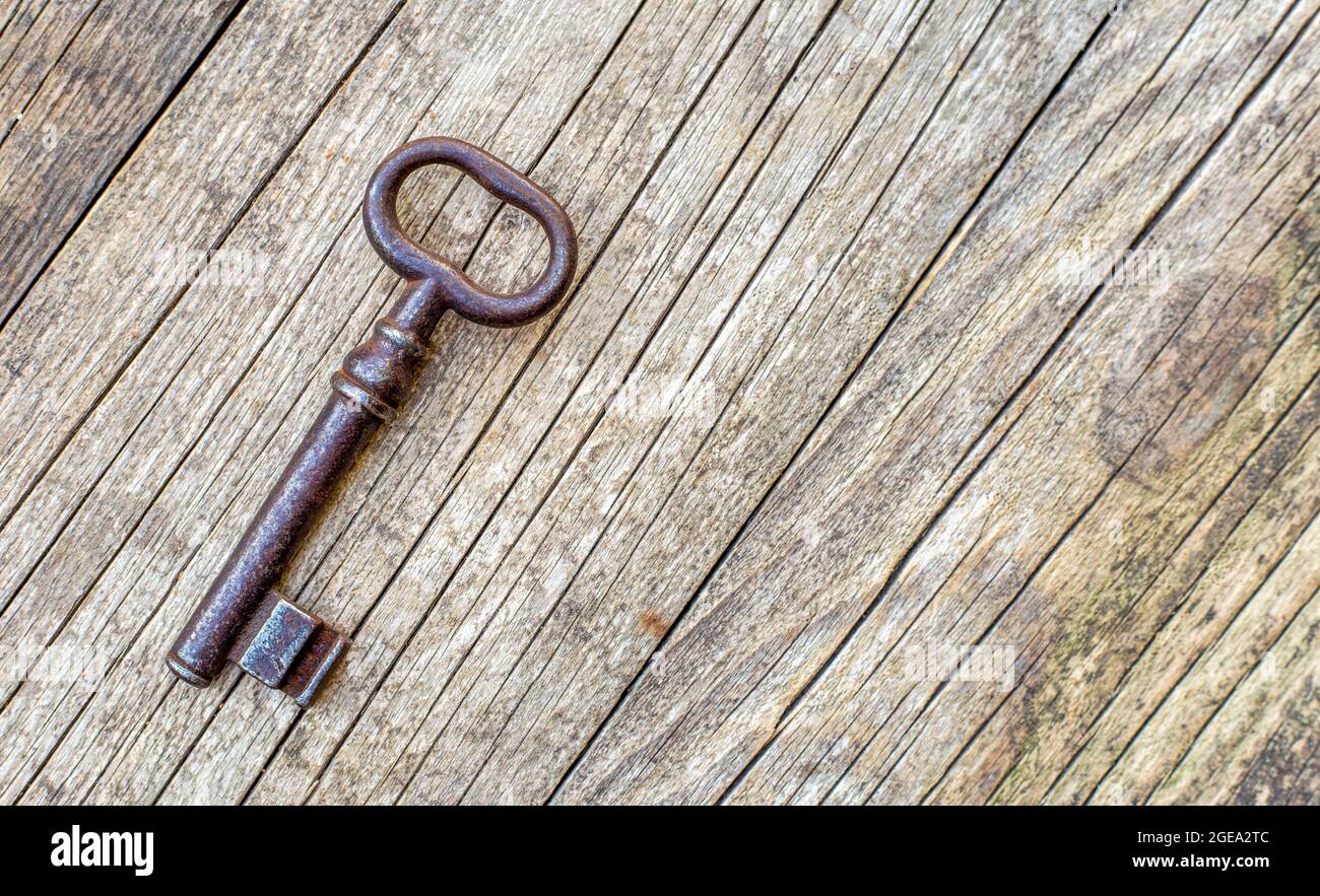 Escape room game concept, old vintage iron key on wooden background ...