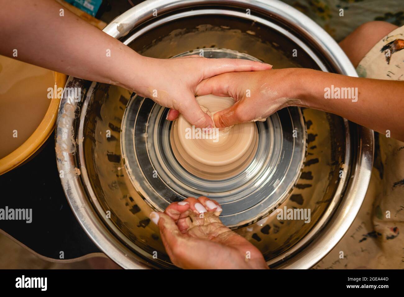 Potter working on potters wheel with clay. Process of making ceramic ...