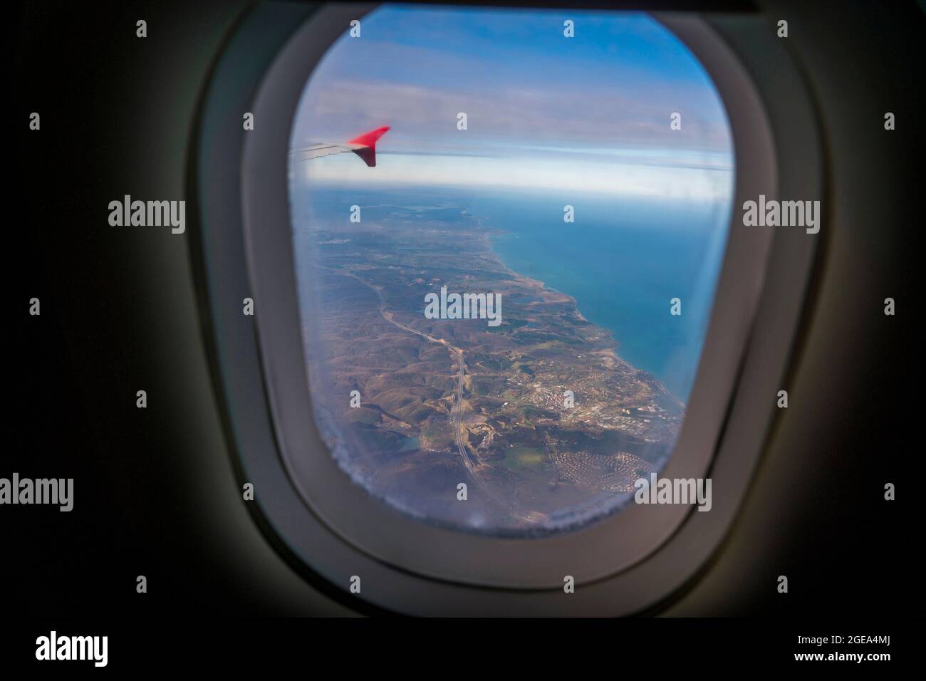 A traveler's view from the plane window as the final descent is made to a new destination. Stock Photo