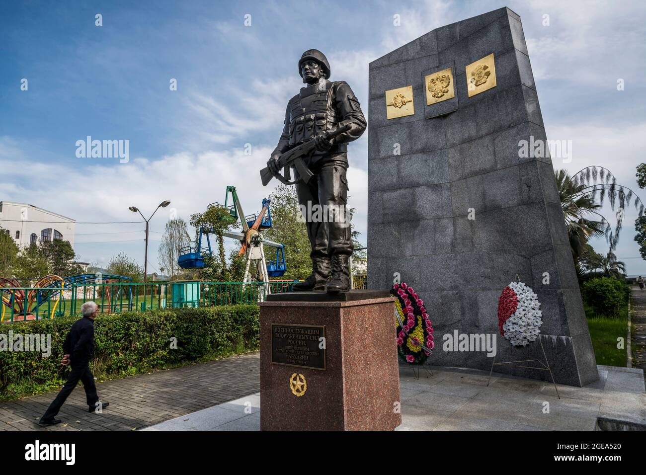 A man walks underneath a memorial to Russian peacekeepers in Sukhum in Abkhazia. Stock Photo