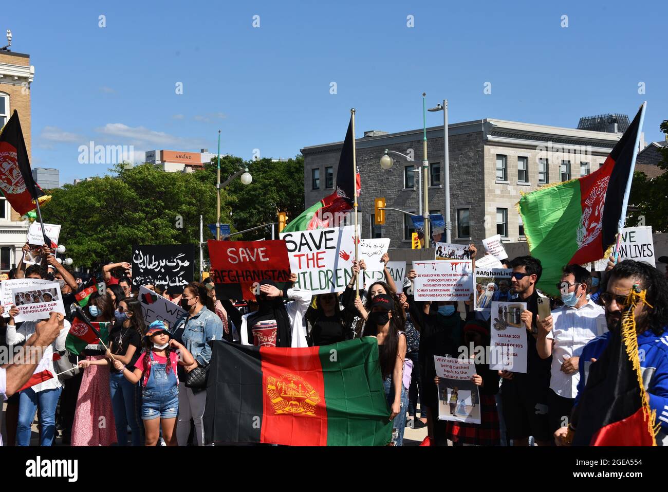 Ottawa, Canada - August 14, 2021:  A crowd gathers at the monument to Canadian Peace Keepers to rally for international help for Afghanistan which is Stock Photo