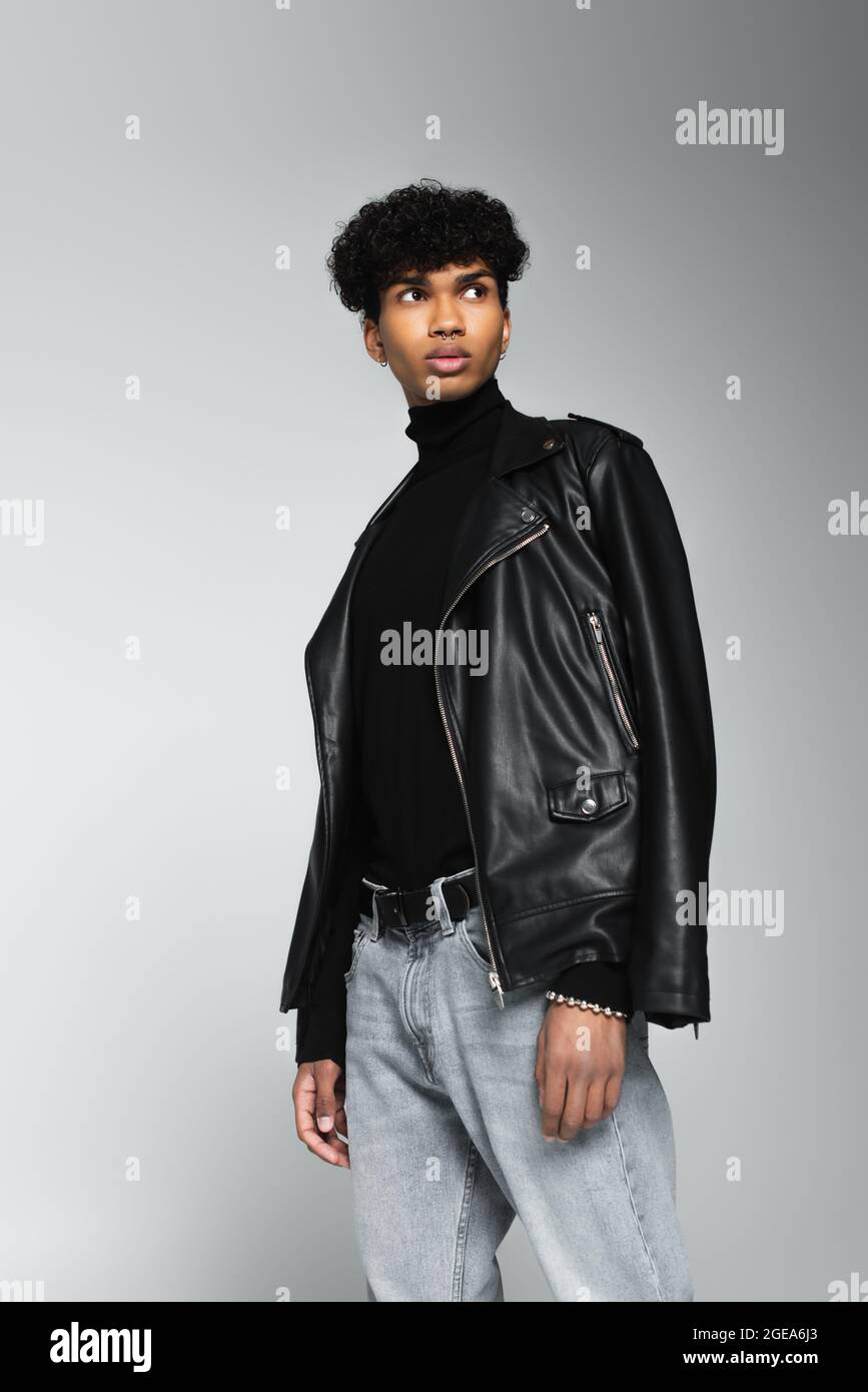 stylish african american man in jeans and black leather jacket on ...